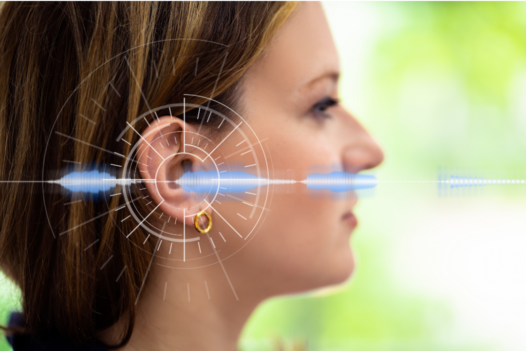 Caucasian woman right side profile with hearing waves shown emitting around her ear.